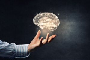 : Image of brain floating above person’s hand