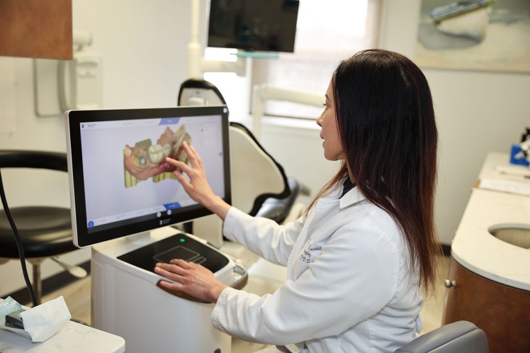 Dr. Carla Bustillo-Gonzalez using the latest technology at Shawsheen Family Dental